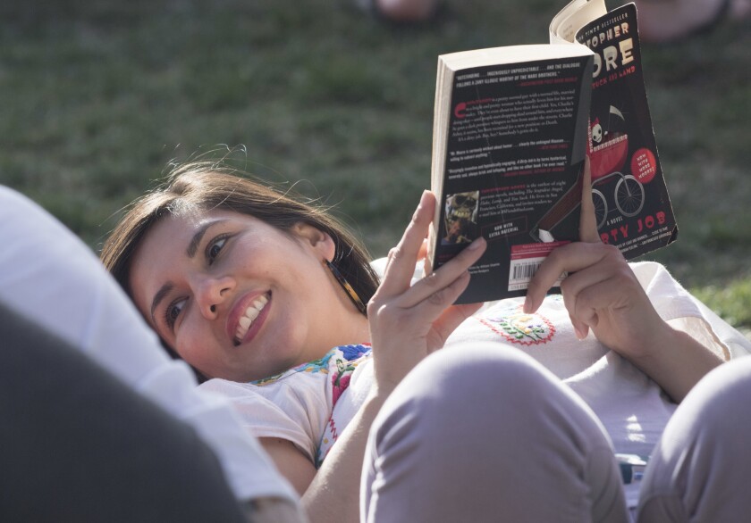 Maria Recarte of South L.A. enjoys a Sunday afternoon with family and a book at the Los Angeles Times Festival of Books at USC.