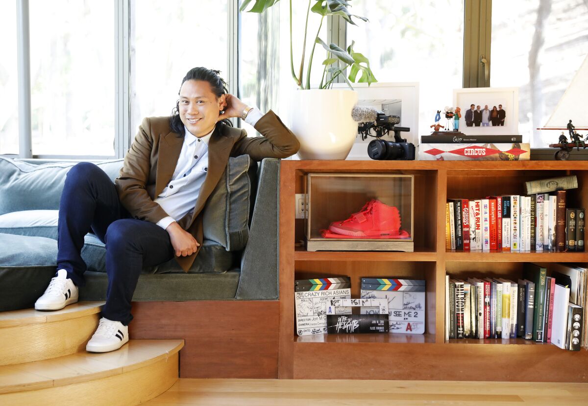 Director Jon M. Chu leans on a bookshelf in his Calabasas home.