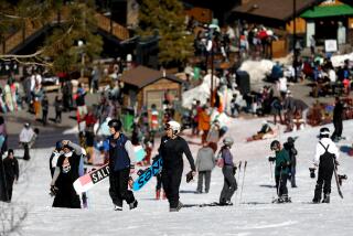 BIG BEAR LAKE, CA - JANUARY 05: Skiers and snowboarders make their way to the lifts at Snow Summit on Wednesday, Jan. 5, 2022 in Big Bear Lake, CA. Ski and snowboarding season is in full swing in mountain resorts like Big Bear. However, the timing of the storm clashed with an aggressive surge of COVID-19. (Gary Coronado / Los Angeles Times)