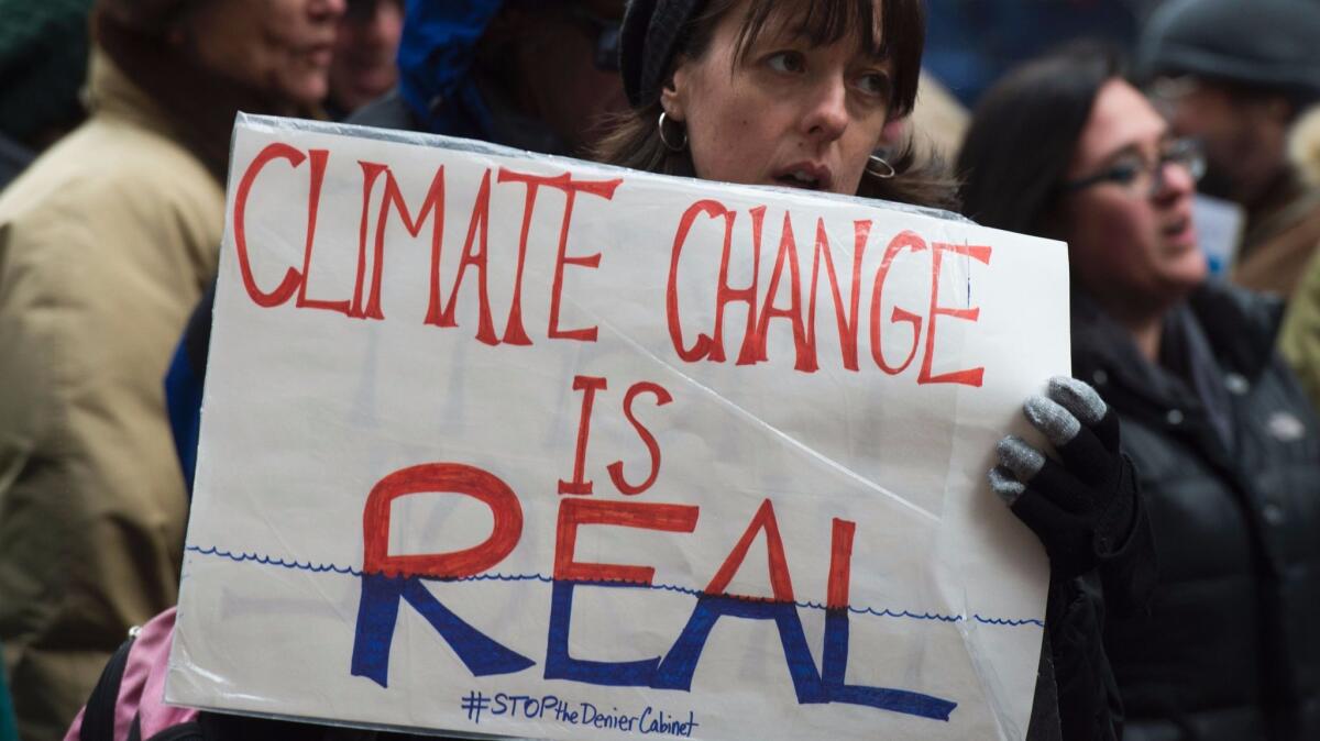 Activists in New York rally to urge politicians to stand against climate change denial.