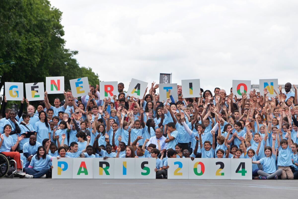 French athletes and children pose for a picture as part of the official launch of Paris' bid for the 2024 Olympics on June 23.