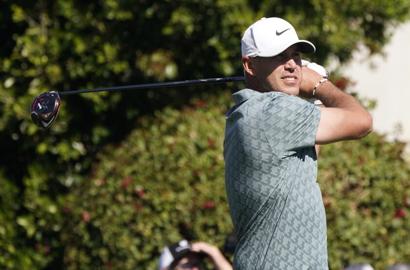 Brooks Koepka watches his tee shot off the second hole during the third round of the Phoenix Open on Feb. 12, 2022.