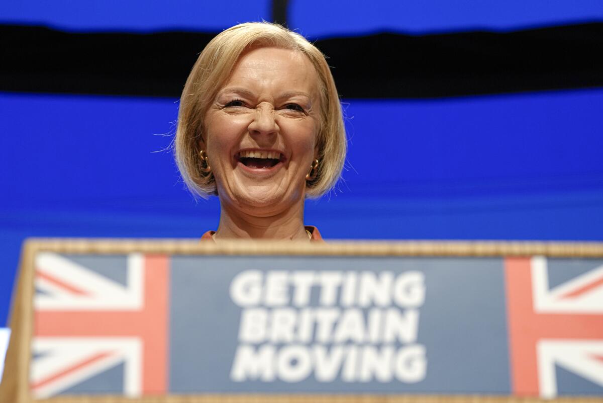 Britain's Prime Minister Liz Truss laughs during her speech at the Conservative Party conference at the ICC in Birmingham, England, Wednesday, Oct. 5, 2022. (AP Photo/Kirsty Wigglesworth)