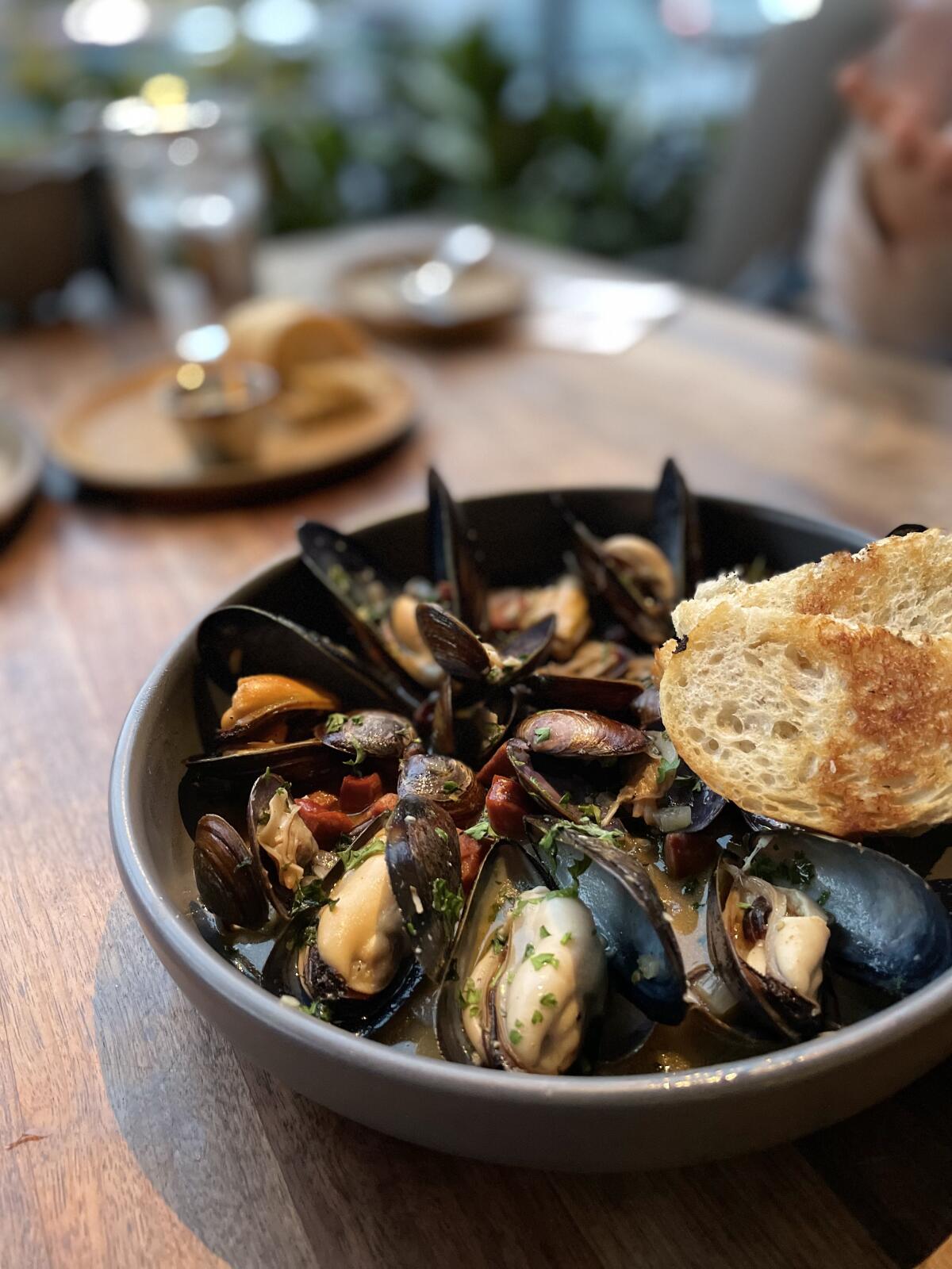 The steamed clams with andouille sausage at King’s Fish House is great for sharing.