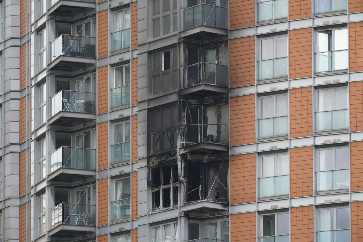 Damage to a 19-storey tower block in New Providence Wharf in London, Friday, May 7, 2021. Firefighters have tacked a blaze in a London apartment tower that has cladding similar to that used on a building where 72 people died in 2017. London Fire Brigade said about 125 firefighters tackled a fire on Friday that spread to three floors of a 19-story building in the city’s docklands. (Yui Mok/PA via AP)