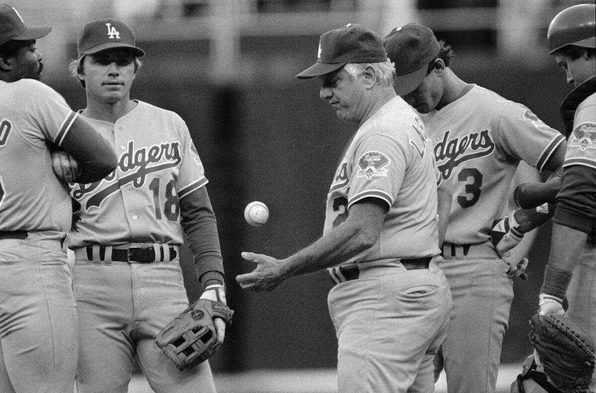 Dodgers manager Tommy Lasorda tosses a ball after removing pitcher Rick Honeycutt.