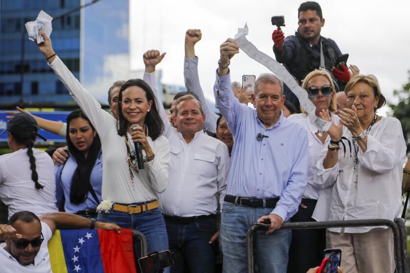 La líder opositora María Corina Machado, a la izquierda, y el candidato opositor Edmundo González sostienen actas de votación desde lo alto de un camión durante una protesta contra los resultados oficiales de las elecciones presidenciales de las que fue declarado ganador el presidente Nicolás Maduro en Caracas, Venezuela, el martes 30 de julio. 2024.