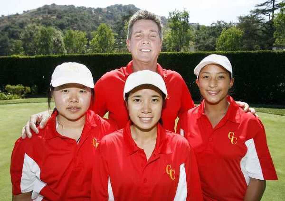 ARCHIVE PHOTO: Coach Greg Osbourne stands with Patraporn Silawanna, Vicanda Ma and Jasmine Daniel of the Glendale Community College women's golf team.