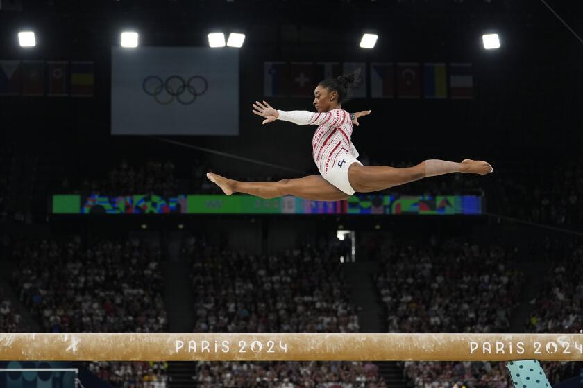 Simone Biles, of the U.S., performs on the balance beam during the women's gymnastics team finals 