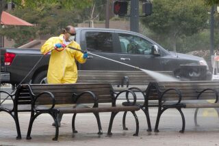 El Cajon CA.- Sept. 21, 2017, Alberto Ruiz, with National Maintenance Services, sprayed a bleach solution on benches at Promenade Park in El Cajon. The city of El Cajon is taking steps to fight the spread of an outbreak of Hepatitis A that has moved through the region. PHOTO/JOHN GIBBINS, Staff photographer, San Diego Union-Tribune) copyright 2017