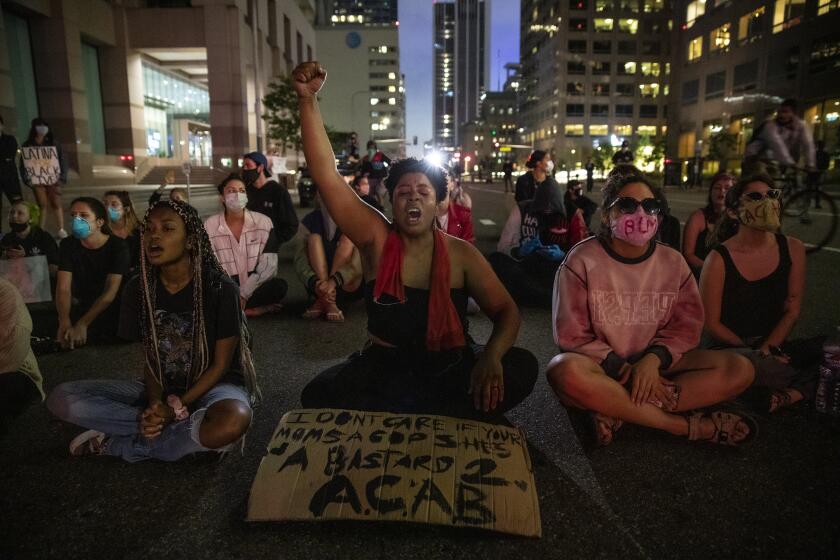 Los Angeles, CA, Thursday, May 28, 2020 - Elyssa Wells yells out protesting the death of George Floyd as she sits with others on Grand Ave., downtown, defying police orders to leave the area. The group finally dispersed after LAPD officers moved to clear the streets. (Robert Gauthier / Los Angeles Times)