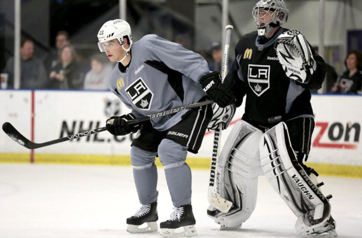 Kings winger Dustin Brown and goaltender Jonathan Quick participate in drills during a practice last season at Staples Center. Both might be out for the game against the Ducks on Saturday night.