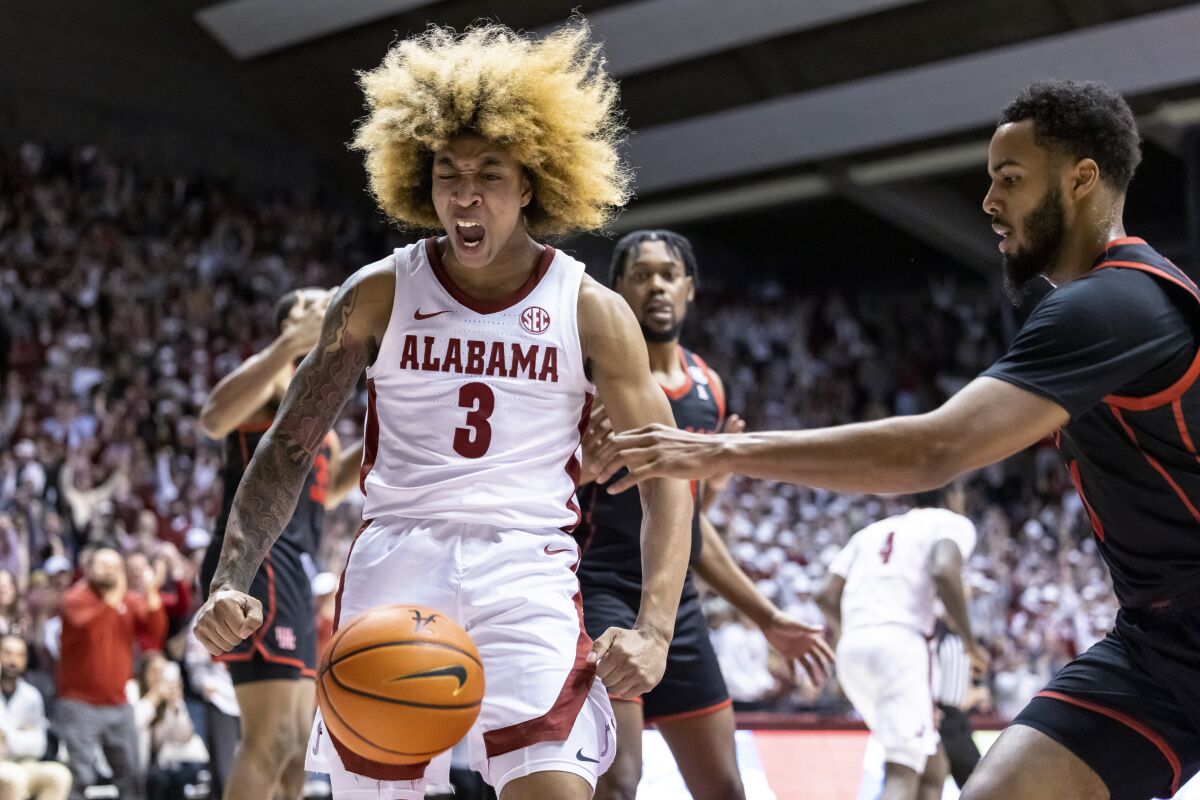Alabama guard JD Davison (3) reacts to a dunk that gave Alabama the lead in the closing seconds against Houston in an NCAA college basketball game Saturday, Dec. 11, 2021, in Tuscaloosa, Ala. (AP Photo/Vasha Hunt)