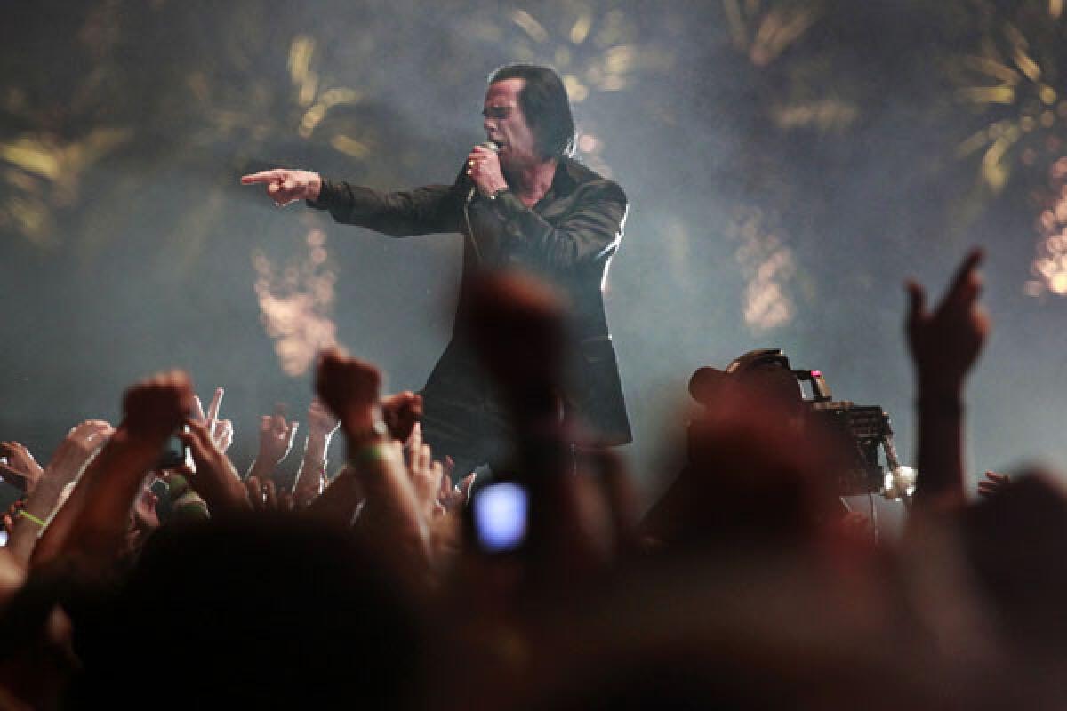 Nick Cave walks into the crowd on the third and final day of the Coachella Valley Music and Arts Festival.