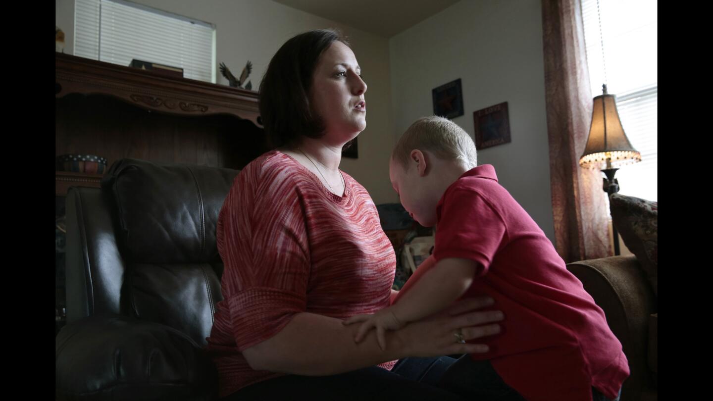 Lori Ballard and son Austin at home in Ft. Bragg, N.C. Her husband has missed nearly a year of their boy's life while away on duty.