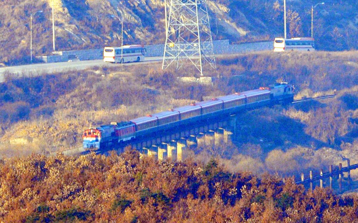 A train carries a South Korean delegation to the North Korean border town of Kaesong on Wednesday for the ceremonial launch of a project to link railways and roads.