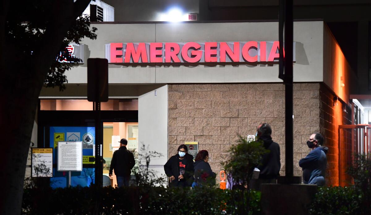 People wait outside the Emergency room of the Garfield Medical Center in Monterey Park, 