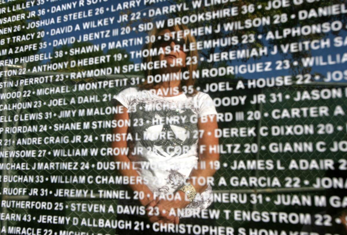 The Northwood Gratitude and Honor Memorial in Irvine was dedicated six years ago. In this 2010 photo, volunteer Pam Rogan is reflected in one of five granite panels etched with the names of those lost in the Iraq and Afghanistan wars.