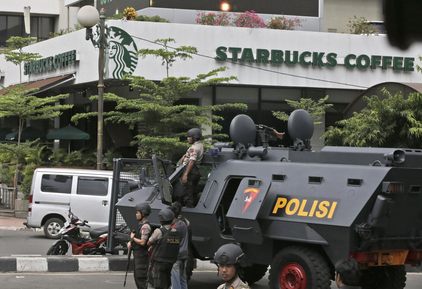 A police armored vehicle is parked outside a Starbucks Cafe near where an explosion went off in Jakarta, Indonesia/