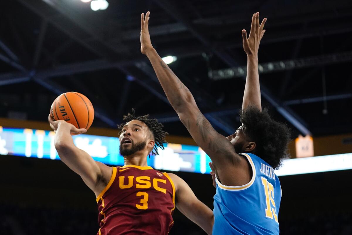 USC forward Isaiah Mobley shoots as UCLA center Myles Johnson defends.