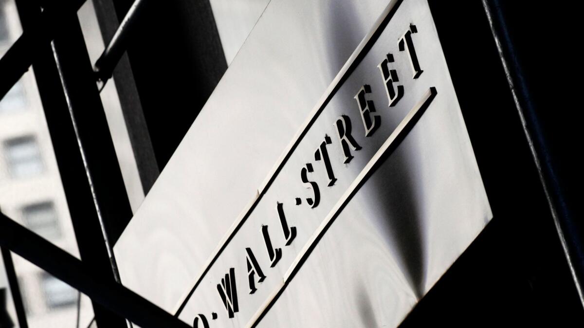 A sign for Wall Street outside the New York Stock Exchange on July 15, 2013.