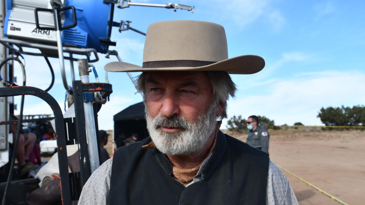 A bearded actor in a cowboy hat on a movie set