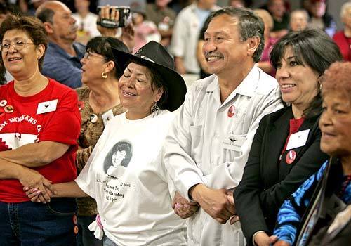 UFW President Arturo Rodriguez joins hands with his fiancee, Sonia Hernandez, right, during a reunion in Delano, Calif., in September marking the 40th anniversary of the grape strike that began there. Today the UFW doesn't have a single contract covering workers in the table grape industry.