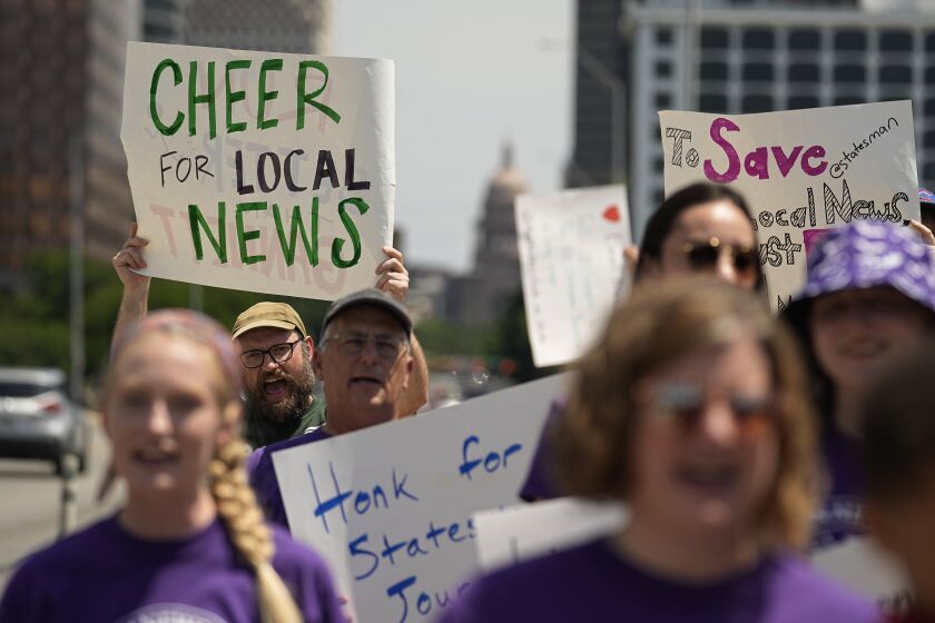Editorial members of the Austin American-Statesman's Austin NewsGuild picket along the Congress Avenue bridge in Austin, Texas, Monday, June 5, 2023. The mostly one-day strike aims to protest the company's leadership and cost-cutting measures imposed since its 2019 merger with GateHouse Media. (AP Photo/Eric Gay)