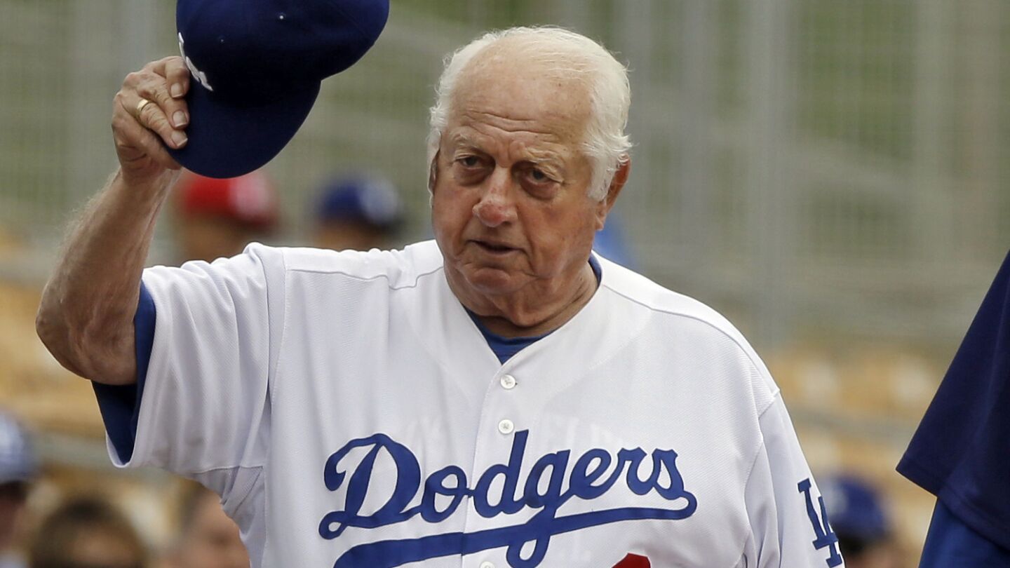 Tommy Lasorda acknowledges fans before a spring game in 2013