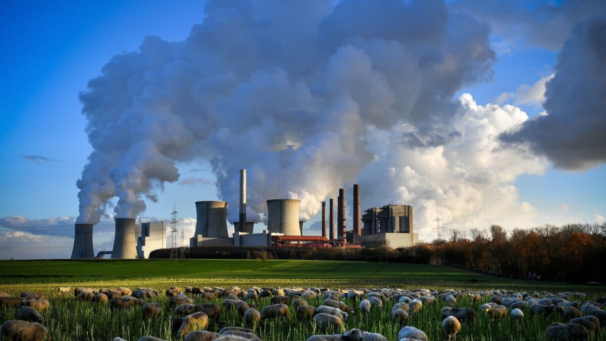 Steam rises from the brown coal-fired power plant Neurath, front center, and Niederaussem, rear left, in Germany. Between 2014 and 2016, global carbon emissions remained largely flat. In 2017, global emissions grew 1.6%. The rise in 2018 is projected to be 2.7%.
