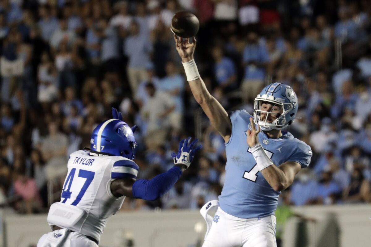 North Carolina quarterback Sam Howell (7) passes over Georgia State linebacker Jhi'Shawn Taylor (47) during the first half of an NCAA college football game in Chapel Hill, N.C., Saturday, Sept. 11, 2021. (AP Photo/Chris Seward)