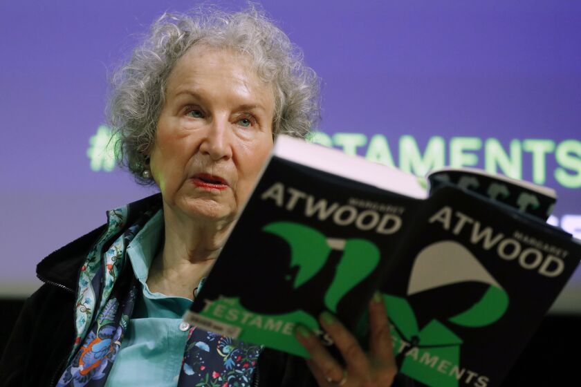 FILE - Canadian author Margaret Atwood holds a copy of her book "The Testaments," during a news conference, Sept. 10, 2019, in London. Filippo Bernardini, who impersonated hundreds of people over the course of the scheme that began around August 2016 and obtained more than a thousand manuscripts including from high-profile authors like Margaret Atwood and Ethan Hawke, was sentenced Thursday, March 13, 2023, in Manhattan federal court, after pleading guilty to one count of wire fraud in January. Bernardini was sentenced to time served, avoiding prison on a felony charge that carried up to 20 years in prison. (AP Photo/Alastair Grant, File)