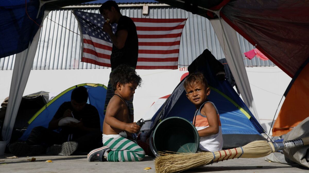 Isaac, 2, left, and his brother Carlitos Dueñas, 4, of Honduras, at a migrant camp in Tijuana, where their family is requesting asylum in the United States.
