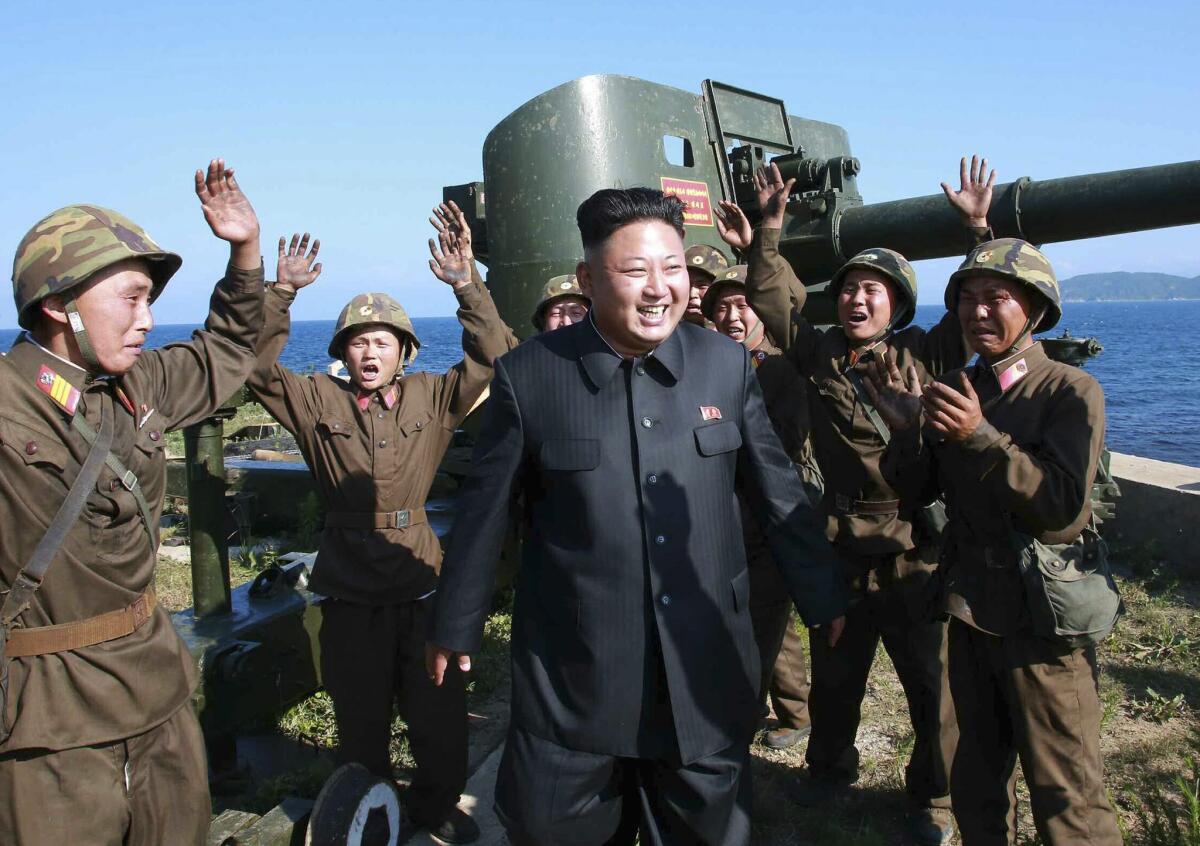 An undated picture released by the North Korean Central News Agency (KCNA) in July shows North Korean leader Kim Jong Un surrounded by cheering soldiers as he toured a front-line military detachment on Ung Islet in the East Sea, North Korea.