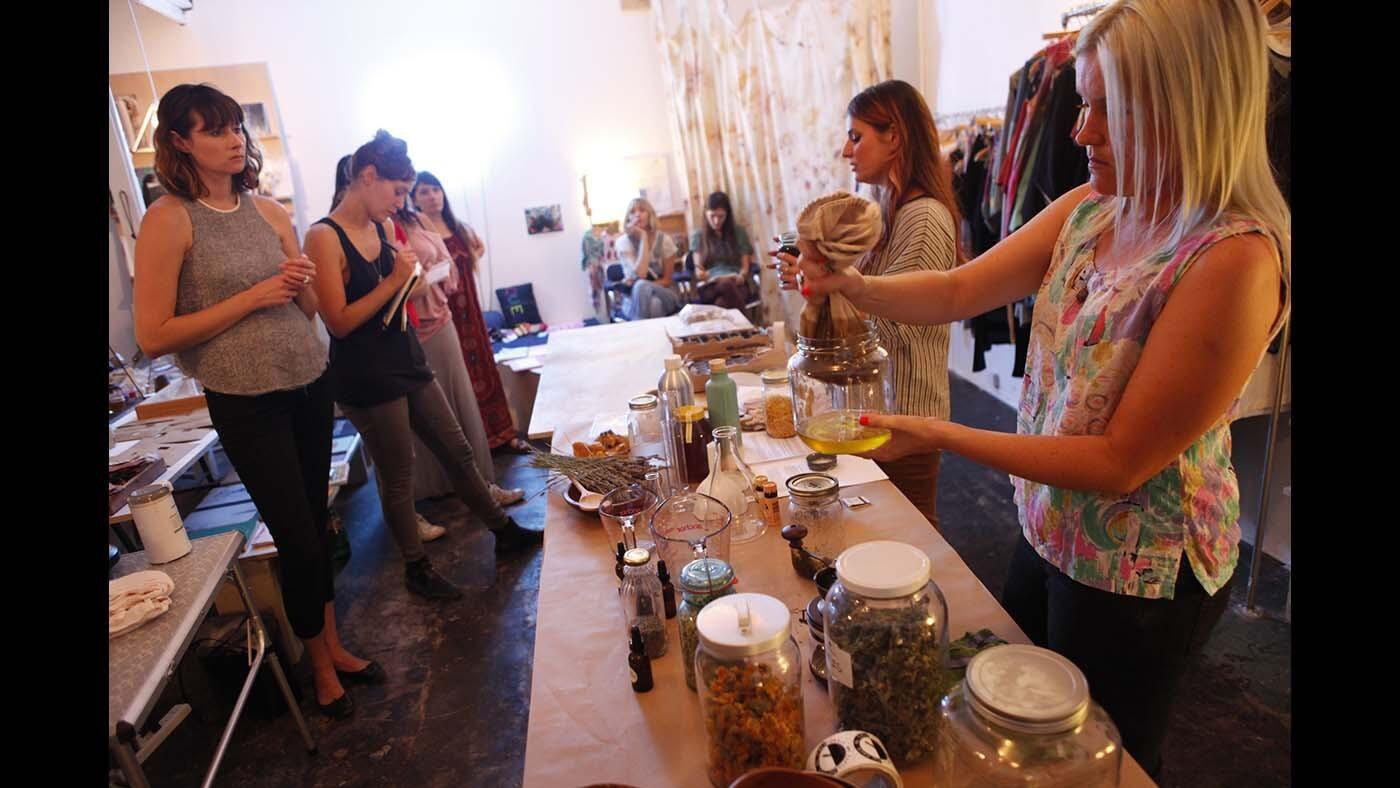 Sara Buscho, right, and Marina Storm, second from right, with Earth Tu Face, give a workshop on how to use medicinal plants and herbs to create natural beauty products at the Otherwild Goods & Services in Echo Park.