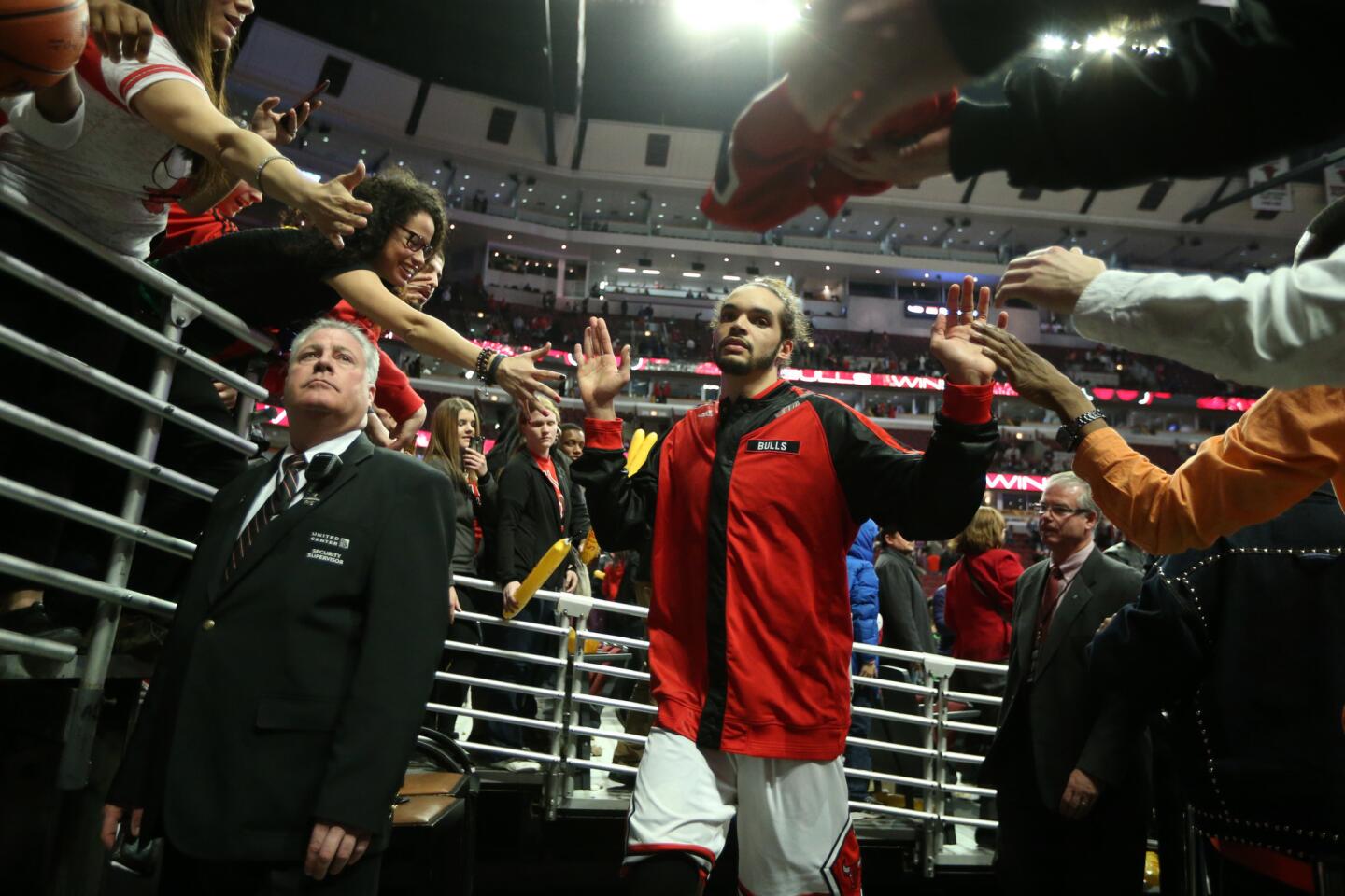 Joakim Noah is congratulated by fans as he heads for the locker room after beating the Rockets at the United Center.