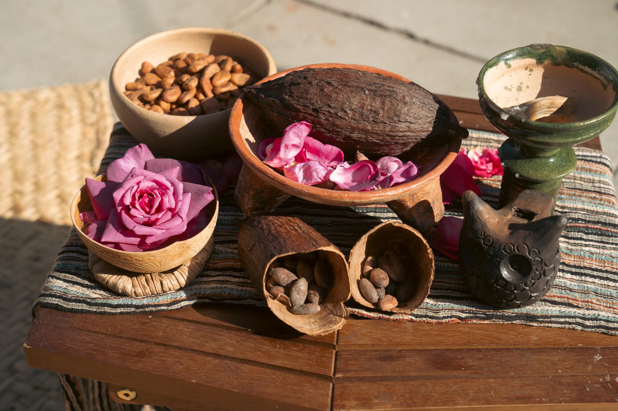 Roses, cocoa and copal on a small table.