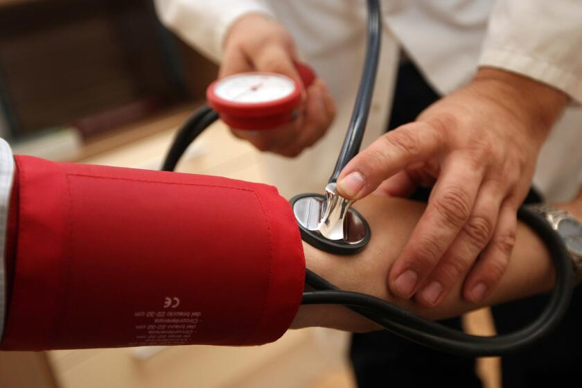 BERLIN, GERMANY - SEPTEMBER 05: A doctor checks a patient's blood pressure on September 5, 2012 in Berlin, Germany. Doctors in the country are demanding higher payments from health insurance companies (Krankenkassen). Over 20 doctors' associations are expected to hold a vote this week over possible strikes and temporary closings of their practices if assurances that a requested additional annual increase of 3.5 billion euros (4,390,475,550 USD) in payments are not provided. The Kassenaerztlichen Bundesvereinigung (KBV), the National Association of Statutory Health Insurance Physicians, unexpectedly broke off talks with the health insurance companies on Monday. (Photo by Adam Berry/Getty Images) User Upload Caption: sc- ** OUTS - ELSENT, FPG - OUTS * NM, PH, VA if sourced by CT, LA or MoD **