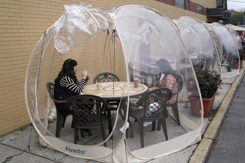 Customers inside a protective bubble at a cafe in Teaneck, N.J. 