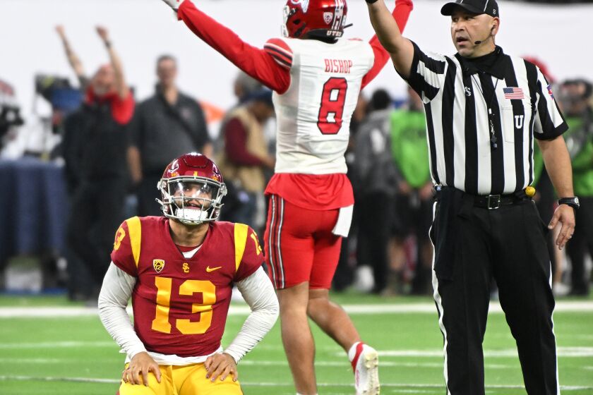USC quarterback Caleb Williams and Utah safety Cole Bishop react after Williams fumbled the ball