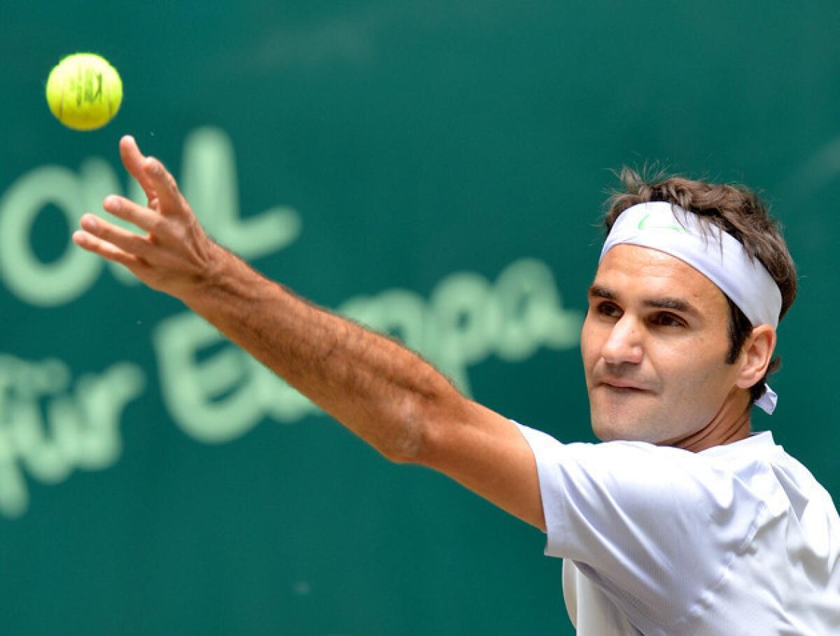Roger Federer prepares to serve the ball to Mikhail Youzhny during their final match at the ATP Gerry Weber Open.