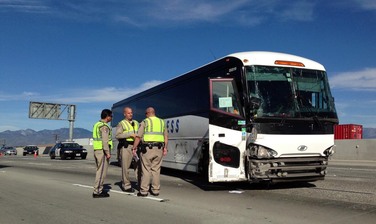 CHP officers stand by a charter bus that collided with a big rig Wednesday morning on the eastbound 60 Freeway in Hacienda Heights.