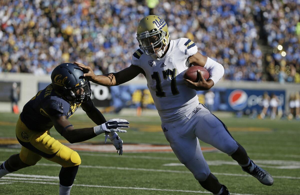 Bruins quarterback Brett Hundley gets past Golden Bears cornerback Darius Allensworth on a 15-yard touchdown run late in the third quarter to give UCLA a 33-28 lead.