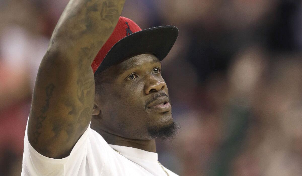 Former Houston Texans wide receiver Andre Johnson acknowledges the crowd during an NBA game between the Rockets and Memphis Grizzlies on March 4.