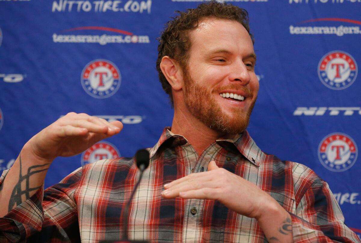 Outfielder Josh Hamilton was all smiles while being introduced by the Rangers after being traded from the Angels.