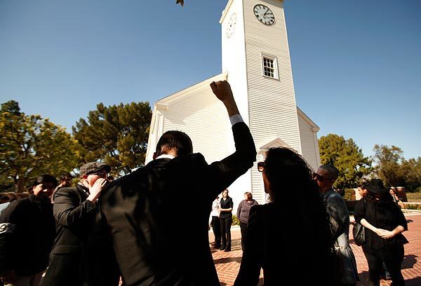 A fist is raised and slogans are chanted outside the Church of the Hills at Forest Lawn Hollywood Hills, where the funeral for Occupy L.A. protester Alex Weinschenker was held.