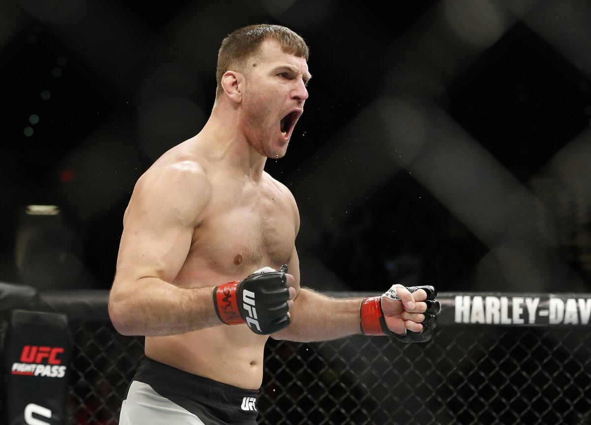 Stipe Miocic celebrates after defeating Andrei Arlovski in a heavyweight mixed martial arts bout at UFC 195.