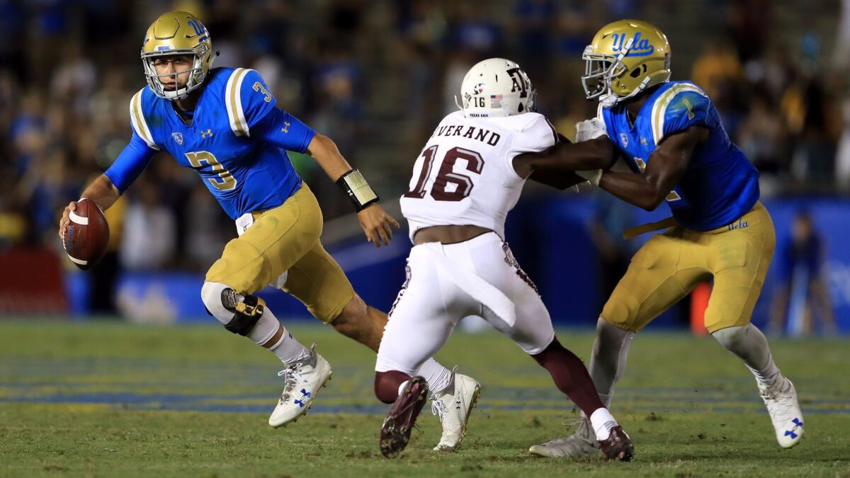 Josh Rosen runs from the pocket as Soso Jamabo blocks Texas A&M defensive back Kemah Siverand.