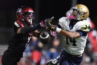 Corona Centennial cornerback Tayten Beyer (left) battles for ball against Vista Murrieta.