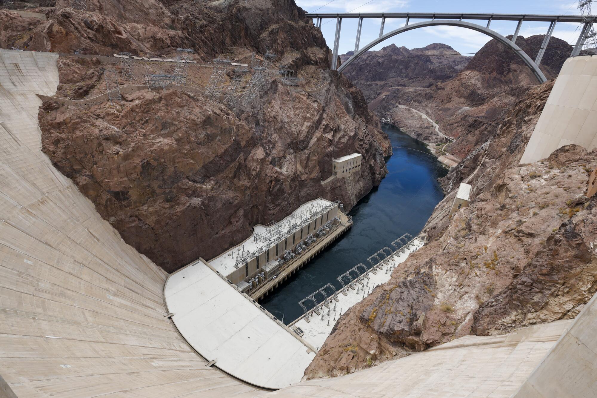 A view looking down Hoover Dam at water flowing into the Colorado River.